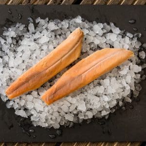 Fresh trout fillets arranged on a bed of ice.